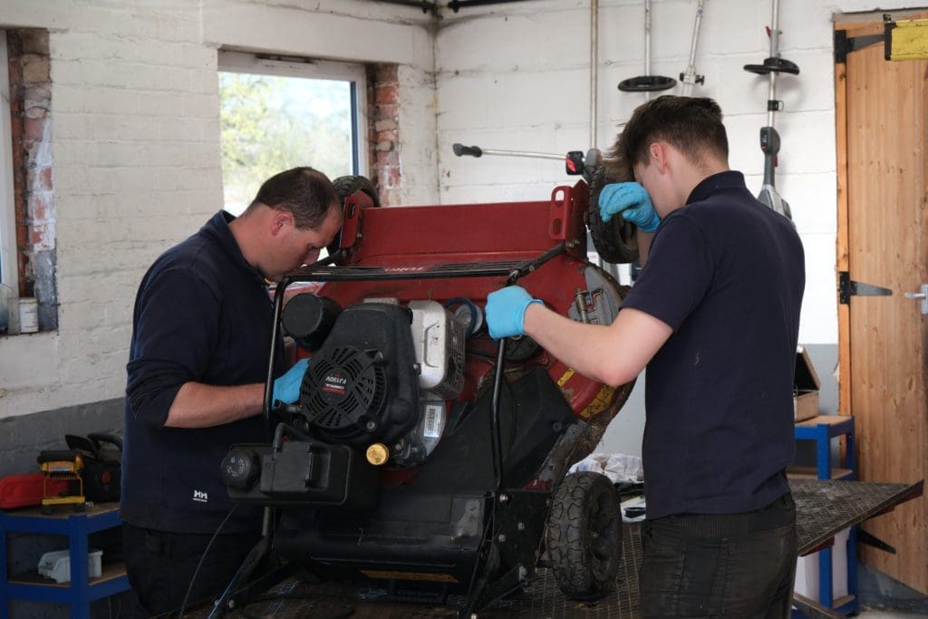 Your Ultimate Guide To Health And Safety In The Ground Maintenance Industry | Middlewich Machinery Peter's dad and brother checking the machine