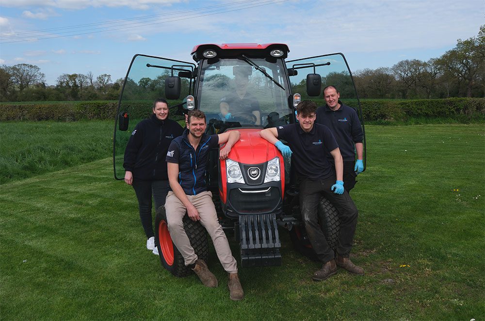 Middlewich machinery's ground care expert team on a tractor