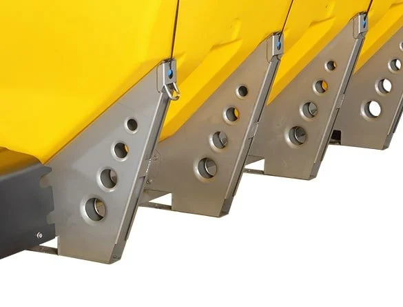 Wessex Snowex Helixx Spreaders | Middlewich Machinery Close-up of a wessex snowex helixx spreader attached to the back of a pickup truck. The yellow spreader is secured with metal brackets and fasteners.